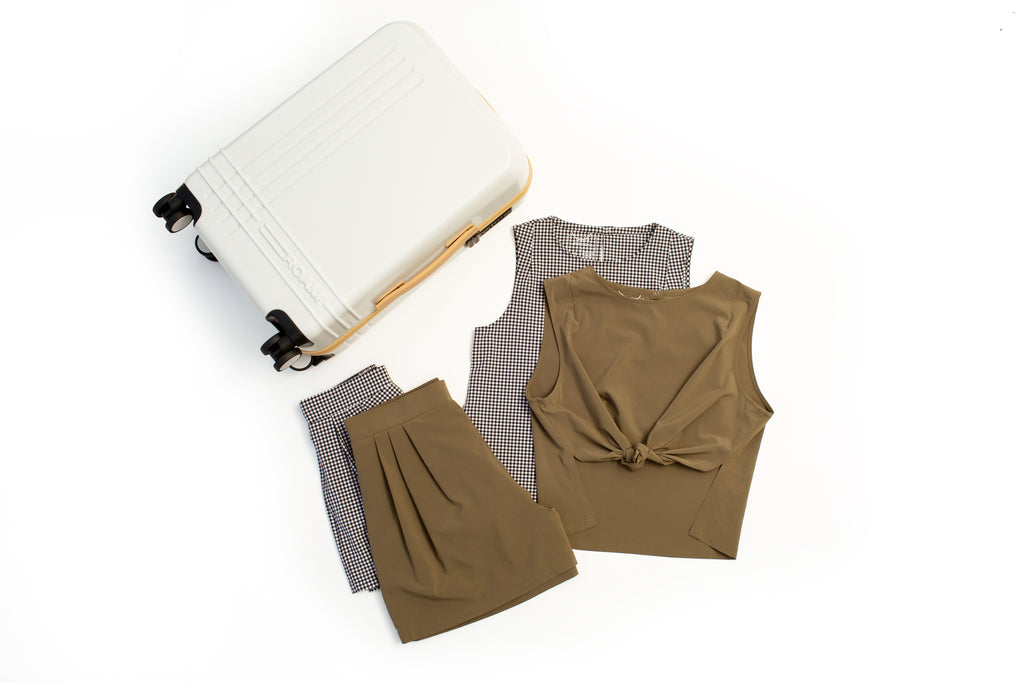 Two travel clothing sets with a suitcase
