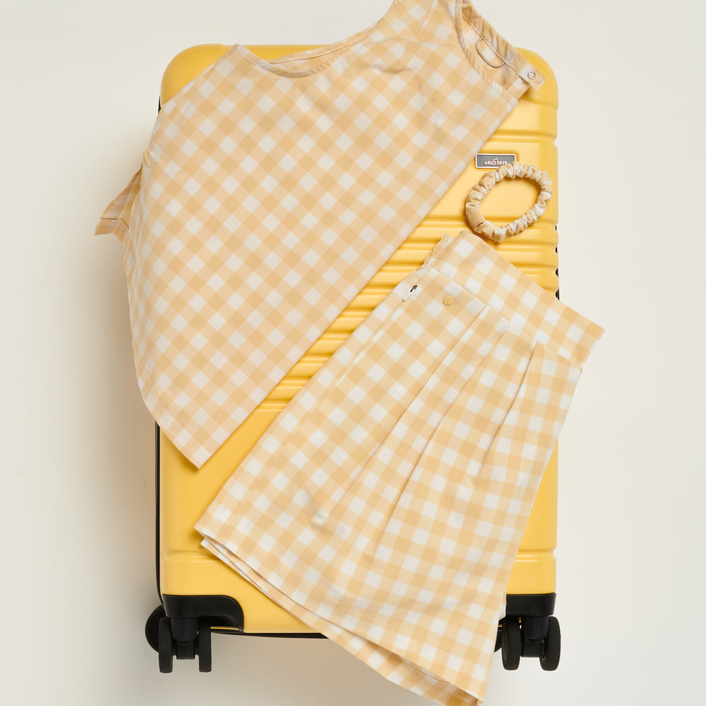 Summer travel clothes on top of a suitcase