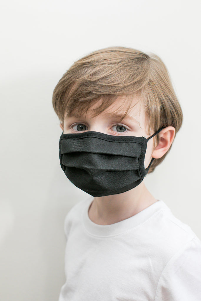 little boy wearing a kids mask