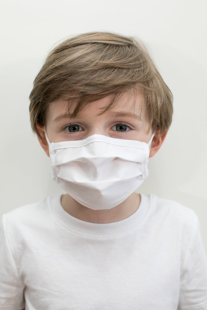 little boy wearing a white face mask from wayre