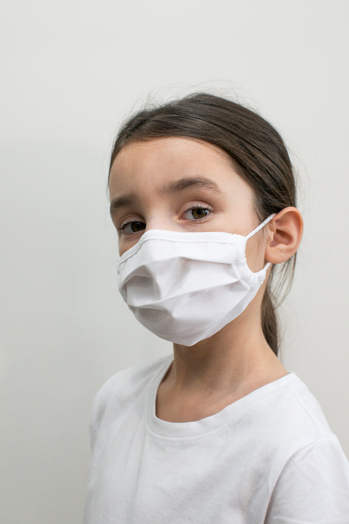 girl wearing a white kids mask
