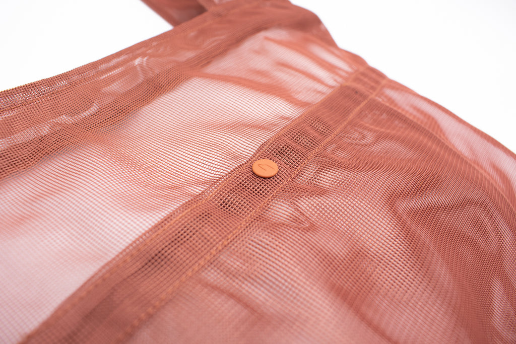 detail of the clay color transparent travel tote from wayre